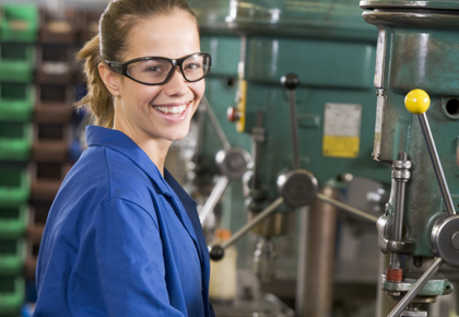 Female machinist in blue coverall