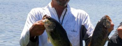 Rob Spohr holding up two bass fish