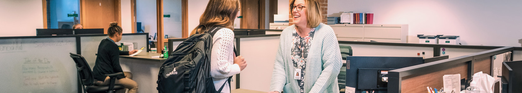 Financial Aid staff person working with a student.