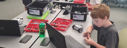 Children working on building robots during MCC's summer camps