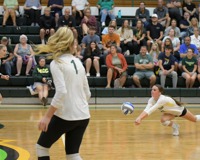 MCC volleyball player dives to hit the ball.