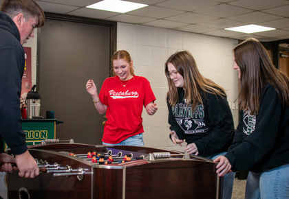 Picture of students playing foosball in the Woodside Cafe