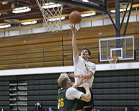 Men's basketball player Trevor Zamarron shooting a layup during practice.