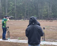 MCC Clay Target shooter aimming gun at a clay pigeon.