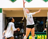 MCC Volleyball player jumps to hit the ball coming over the net.