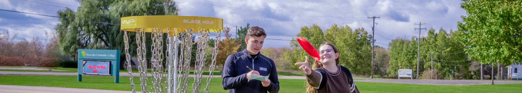 Picture of two kids playing disc golf