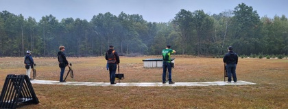 MCC clay target team lined up preparing to shoot at a competition.
