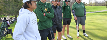 MCC golf team standing on green.