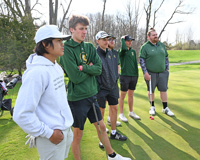 MCC golf team standing on green.