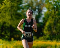 MCC women's cross country runner Abby Davis running on a course.